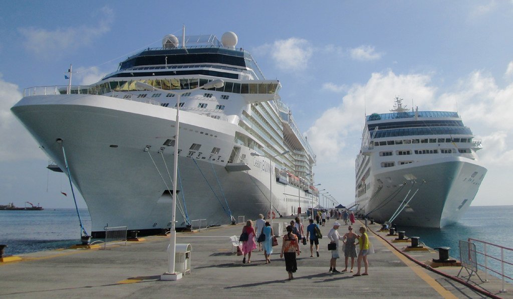 Multiple cruise ships of different sizes docked at cruise port terminal