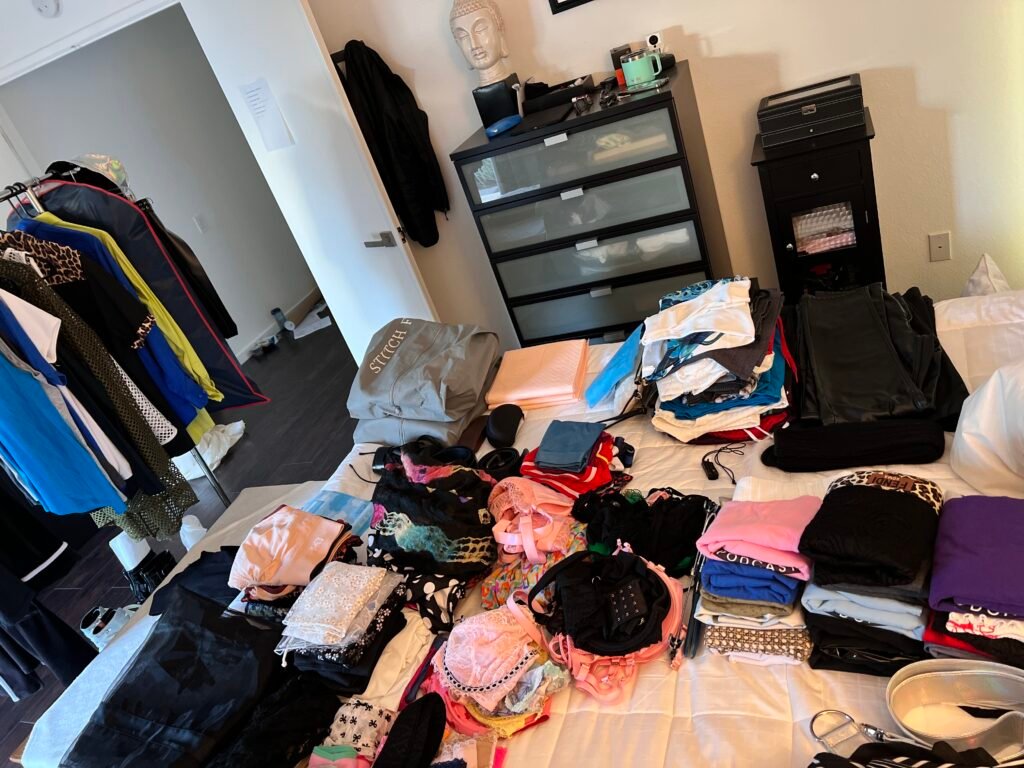 packing in preparation for cruise with everything laid out on bed