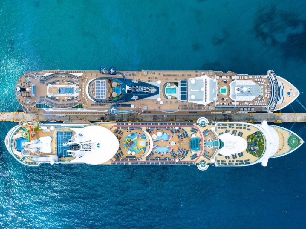Aerial view of modern cruise ship showing multiple pools and deck activities
